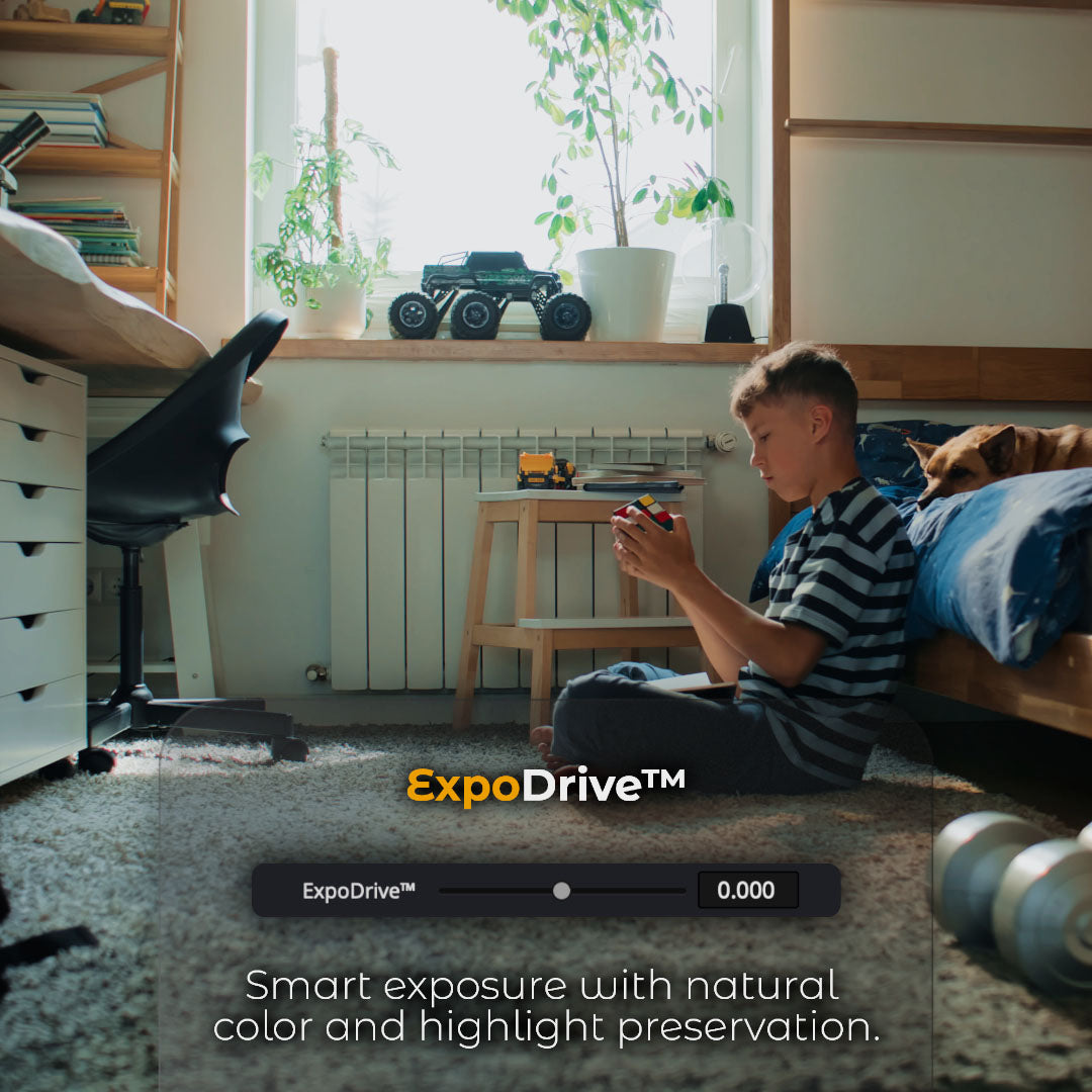HueCrafter© ExpoDrive™. Smart exposure with natural color and highlight preservation. Boy with a puzzle cube on a bedroom rug by a bright window, with the ExpoDrive™ slider at 0.000.